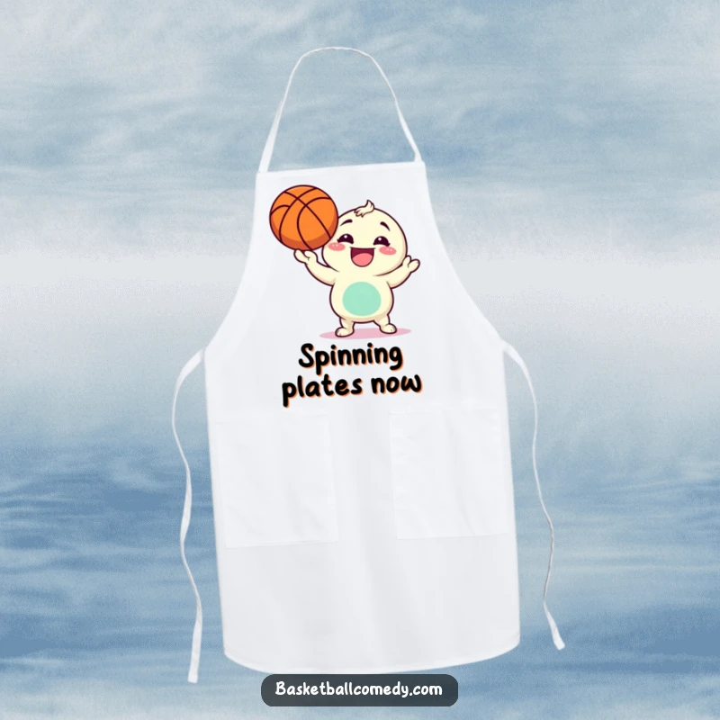 Funny apron depicting a character gleefully spinning a basketball on its finger, ready to add fun to any kitchen task.